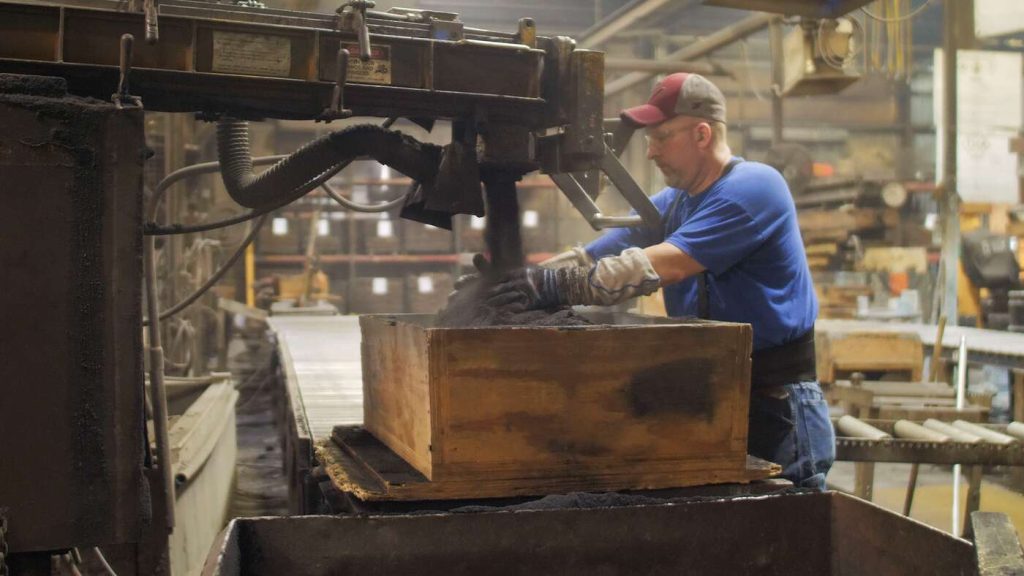 Airset molding: pouring sand over pattern to create mold